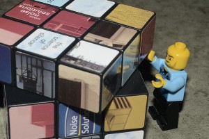 Not only is a rubiks cube hard to solve, but this one is a picture one and this poor little guy can hardly reach!